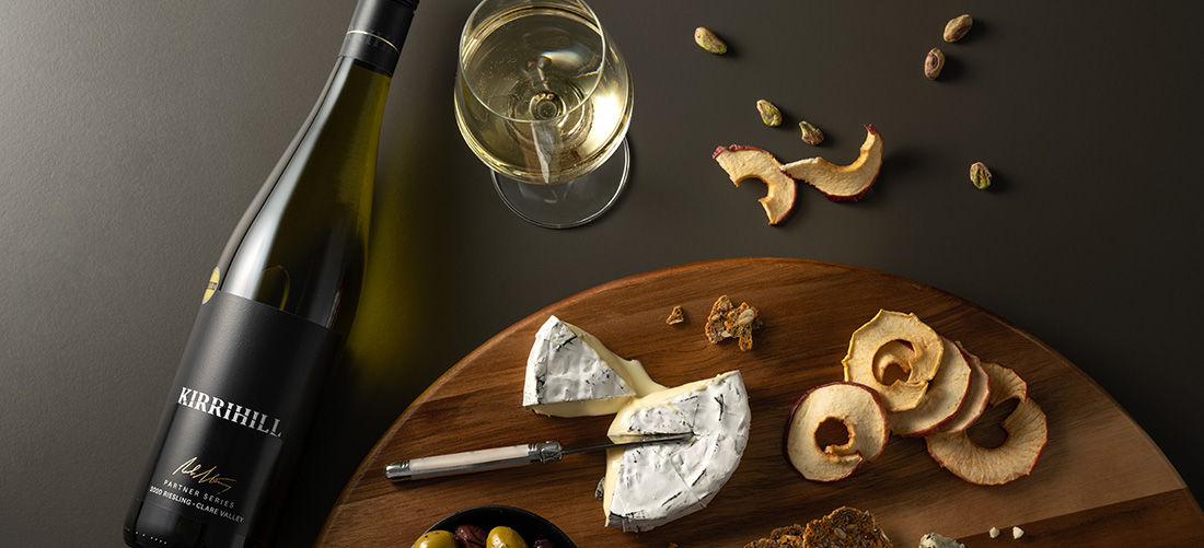 Bottle of Kirrihill wine with cheese plate 